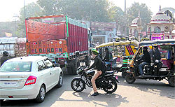 A commuter makes his way on the road outside Sultanwind Gate in Amritsar on Friday