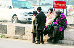 Beggars sit on the divider in chilly winter in Amritsar