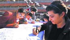 Students of DAV-15, Chandigarh, sign during a signature campaign on women safety