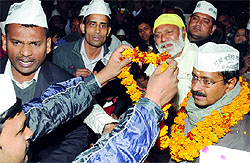 A day before taking oath as Delhi Chief Minister, AAP leader Arvind Kejriwal being greeted by local people during the Mohalla Sabha at his constituency in New Delhi on Friday