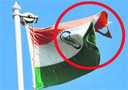 A torn National Flag flutters atop the mini-secretariat in Karnal.