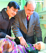 ENT specialists Dr JM Hans (right) and Dr Rajeev Kapila along with three-year-old Devansh after a cochlear implant surgery in Ludhiana on Friday. Photo: Inderjeet Verma