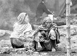 Women sit around a bonfire in Kolkata on Friday
