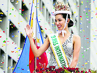 Miss International 2013 winner of the Philippines, Bae Rose Santiago, waves at the crowd during a victory parade in Manila on Friday. Santiago won the top position at the 53rd Miss International pageant held on December 7 in Japan