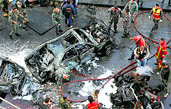 Lebanese security forces and firefighters at the site of explosion that rocked Beirut on Friday