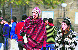 A foreign couple in woollens take a stroll on The Ridge in Shimla on Saturday