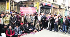 Shopkeepers hold protest against property tax at Mandi Fantonganj in Jalandhar on Saturday