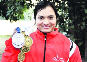 Weightlifter Meena Kumari shows her medals in Jalandhar on Saturday