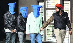 A policeman takes away the snatchers  at the Division No. 5 police station in Jalandhar on Saturday