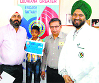 Boy Mohit with surgeon HS Bedi (right) and office-bearers of the Rotary Club Greater, Ludhiana. a file photograph
