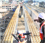Workers erect steel girders on the Lakkar Bridge in Ludhiana on Saturday. Tribune Photo: Himanshu Mahajan
