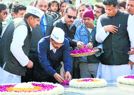 Delhi Chief Minister Arvind Kejriwal paying tributes at Rajghat after taking oath in Delhi on Saturday.