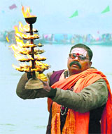 A priest performs a ritual during "Ganga poojan" to mark the beginning of the Magh Mela festival in Allahabad on Saturday.