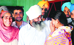 Released detainee Shamsher Singh Shera (white turban) with his family members in Kanwarpur village near Rajpura on Saturday. Tribune photo: JS Virdi