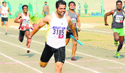 Gurlal Singh leads his team to the gold in the mens 4x100m relay final in Patiala on Saturday. Tribune photo
