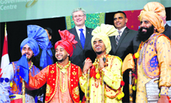 A slice of India: Canadas Prime Minister Stephen Harper (C) poses with performers during Baisakhi celebrations in Ottawa