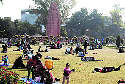Tourists enjoy the sunshine amidst cold wave sweeping the region at Jallianwala Bagh in Amritsar on Sunday