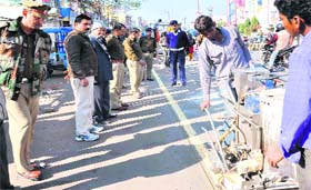 Workers draw a yellow line on the Chandracharya square stretch in Haridwar on Sunday