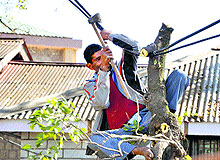 A worker hangs on an electricity without any safety kit at the Main Bazaar in Dharamsala on Sunday