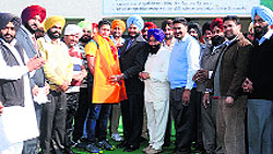 Zila Parishad member Joginder Singh Naraingarh and club volunteers honour World Cup Kabaddi player Sultan Shamashpur at Majri Kishne Wali village