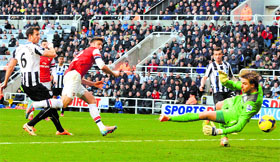 Arsenals Olivier Giroud heads and scores against Newcastle United during their English Premier League match at St James Park in Newcastle on Sunday.
