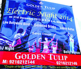 A hoarding highlighting the New Year eve bash at a hotel in Amritsar on Monday.