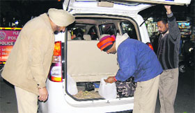 Policemen check a car during a drive in Amritsar on Monday.