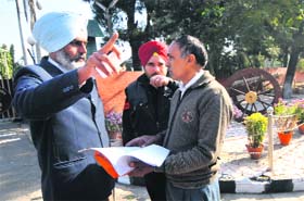 Om Parkash speaks to security officials at the Punjab Raj Bhawan in Chandigarh on Monday