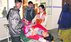 Relatives look after their patient following a strike by nurses at Doon Hospital in Dehradun on Monday. A Tribune photograph 
