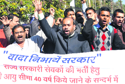 Unemployed protest cut in age limit for recruitment in government jobs in Dehradun on Monday. A Tribune photograph