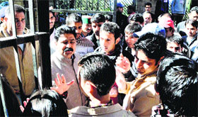 Students give a memorandum to EC members at the HPU in Shimla on Monday.