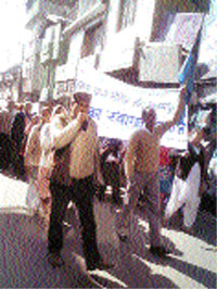 Ex-servicemen hold a rally in support of their demands at Palampur on Monday.