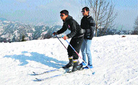 Children enjoy skiing at Kufri near Shimla.