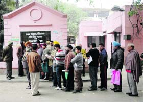 Residents wait in a queue to deposit property tax at Town Hall in Amritsar
