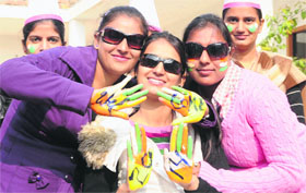 girls paint their hands with the message welcoming the New Year.