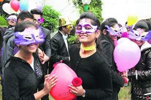 Students of St Soldier Group of Institutions participate in a mask party to welcome the New Year in Jalandhar on Tuesday. 