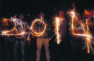 Boys create the New Year 2014 with fireworks at a New Year party in Jalandhar on Tuesday.