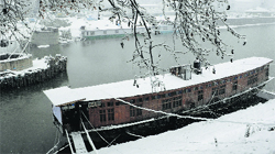 A houseboat covered with snow in Srinagar on Tuesday. Tribune photo: Amin War