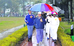 Participants walk amid rain during the walk for fun organised by the Army Medical Corps in Udhampur on Tuesday. a tribune photograph 
