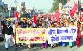 Activists of various organisations raise slogans against the state government during a protest march in Jagraon on Tuesday