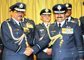 Outgoing Air Chief Marshal NAK Browne (left) shakes hands with his successor Arup Raha at the Air Force Headquarters in New Delhi on Tuesday