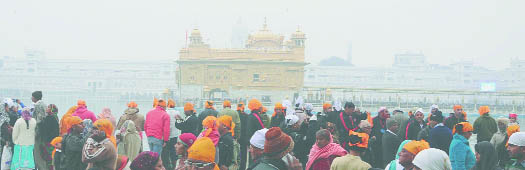 Devotees throng the Golden Temple on New Years Eve in Amritsar.