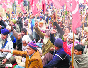 Villagers stage a dharna in front of Bilga police station in Phagwara on Tuesday.