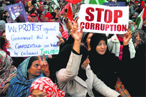 Supporters of Pakistani cleric Tahirul Qadri leader of the Pakistan Awami Tehreek protest in Lahore. Thousands have gathered to protest against inflation, unemployment, and lawlessness in the country. 