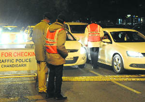Policemen check vehicles during a drive on Tuesday night at Sector 26, Chandigarh.
