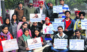 Computer teachers hold a protest at Sector 20 in Chandigarh on Wednesday. 