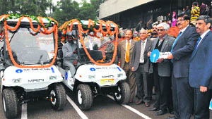 Lingaraj Mahapatra, Chief General Manager, State Bank of India, Chandigarh Circle, hands over the keys of four battery-operated golf carts to Dr Yogesh Chawla, Director, PGI, at a function in Chandigarh on Wednesday. 