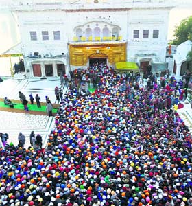 Sea of devotion: A huge rush of devotees on the first day of the New Year at the Golden Temple in Amritsar on Wednesday