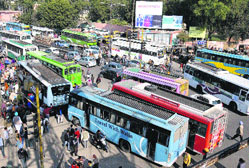 Private bus operators block the area outside the bus stand by parking their vehicles on the road in Bathinda on Thursday. 