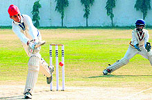 A batsman plays a shot as the wicketkeeper looks on during an inter-school cricket tournament at Sector 26, Chandigarh, on Thursday
